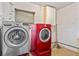 This laundry room features side-by-side machines, a convenient window, and wall-mounted storage for household essentials at 6031 W Ridgewood Ave, Orlando, FL 32835