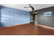 View of the living room with blue and black walls and wood laminate floors at 6031 W Ridgewood Ave, Orlando, FL 32835