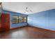 Inviting living room with hardwood floors, a ceiling fan, and a large window at 6031 W Ridgewood Ave, Orlando, FL 32835