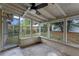 This screened porch offers an airy retreat with concrete flooring and white trim to enjoy the outdoors at 6031 W Ridgewood Ave, Orlando, FL 32835