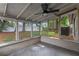 The screened porch offers a peaceful outdoor retreat with views of the backyard and ample space for entertaining at 6031 W Ridgewood Ave, Orlando, FL 32835