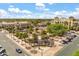 Beautiful aerial view of the town center with palm trees and a charming fountain, surrounded by upscale buildings and lush greenery at 613 Nuevo Leon Ln, The Villages, FL 32159