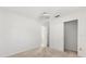 Neutral bedroom with carpet, overhead lighting, closet, and adjoining doorway at 613 Nuevo Leon Ln, The Villages, FL 32159