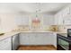 Well-lit kitchen featuring white cabinetry, sleek countertops, and modern appliances at 613 Nuevo Leon Ln, The Villages, FL 32159