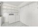 Functional laundry room with washer, dryer, and wire shelving for ample storage at 613 Nuevo Leon Ln, The Villages, FL 32159
