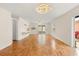 Open living room with hardwood floors, modern lighting fixture, and ample space at 613 Nuevo Leon Ln, The Villages, FL 32159
