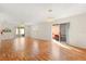 Spacious living room featuring wood floors and access to screened porch and patio at 613 Nuevo Leon Ln, The Villages, FL 32159
