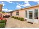 Charming backyard patio area with beautiful brick pavers and comfortable outdoor seating, perfect for relaxing or entertaining at 613 Nuevo Leon Ln, The Villages, FL 32159