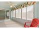 Bright sunroom features tile flooring, large windows, and a ceiling fan for comfortable relaxation at 613 Nuevo Leon Ln, The Villages, FL 32159