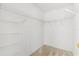 Walk-in closet features wire shelving for organized storage at 613 Nuevo Leon Ln, The Villages, FL 32159