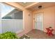 Charming home exterior featuring a covered entryway, large window, and colorful front door at 613 Nuevo Leon Ln, The Villages, FL 32159