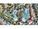 Aerial view of the community lazy river pool with various resort amenities and plenty of shade, a perfect relaxation spot at 7012 Oakwood St, Davenport, FL 33837