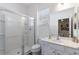 Bright bathroom featuring glass shower and white cabinets at 7012 Oakwood St, Davenport, FL 33837