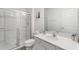 Bright bathroom with a glass-enclosed shower, white vanity, and modern fixtures at 7012 Oakwood St, Davenport, FL 33837