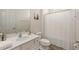 Clean, bright bathroom featuring a vanity with sink and a shower with a white curtain at 7012 Oakwood St, Davenport, FL 33837