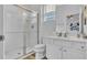 Bathroom features a glass shower, white cabinets, and a white toilet at 7012 Oakwood St, Davenport, FL 33837