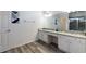 Bathroom featuring white cabinets, granite countertops and dual sinks at 7012 Oakwood St, Davenport, FL 33837
