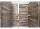 Modern bathroom shower with wood-look tile and glass door provides a luxurious experience at 7012 Oakwood St, Davenport, FL 33837
