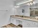 Bright bathroom features a double vanity, granite counters and large mirror at 7012 Oakwood St, Davenport, FL 33837