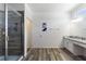 Bathroom featuring a shower, white cabinets, and granite countertops at 7012 Oakwood St, Davenport, FL 33837
