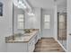 Stylish bathroom with double vanity, granite countertops, and a glass-enclosed shower at 7012 Oakwood St, Davenport, FL 33837