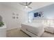 Comfortable bedroom features a large bed, light blue accent wall and modern decor at 7012 Oakwood St, Davenport, FL 33837