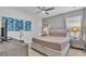 Comfortable bedroom with a neutral color scheme, a large bed, and natural light at 7012 Oakwood St, Davenport, FL 33837