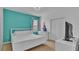 Bright bedroom with a full-sized bed, a window, and simple decor for a calming space at 7012 Oakwood St, Davenport, FL 33837