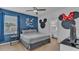 Bedroom featuring a king size bed, ensuite bathroom, and Mickey Mouse themed decor at 7012 Oakwood St, Davenport, FL 33837