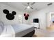 Bright bedroom featuring playful Disney-themed decor and a comfortable bed at 7012 Oakwood St, Davenport, FL 33837