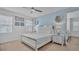 Airy bedroom featuring a king size bed, ensuite bathroom, and modern decor at 7012 Oakwood St, Davenport, FL 33837