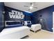 Star Wars themed bedroom featuring two beds and a fan at 7012 Oakwood St, Davenport, FL 33837
