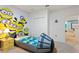 ' bedroom with Minion-themed decor, including a large mural and unique car-shaped beds at 7012 Oakwood St, Davenport, FL 33837