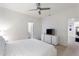 Bedroom featuring white bedding, a TV, and access to the bathroom at 7012 Oakwood St, Davenport, FL 33837