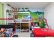 Fun themed ' bedroom with bunk beds and Jurassic World decor and mural at 7012 Oakwood St, Davenport, FL 33837