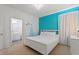 Bright bedroom featuring a modern white bed and view into the bathroom at 7012 Oakwood St, Davenport, FL 33837