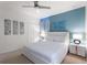 Bedroom featuring white bedding, modern decor, and a ceiling fan at 7012 Oakwood St, Davenport, FL 33837