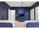 Bedroom with matching blue beds and furniture and neutral colored carpet at 7012 Oakwood St, Davenport, FL 33837