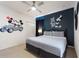 Charming bedroom featuring a comfortable bed and playful Disney-themed decor at 7012 Oakwood St, Davenport, FL 33837