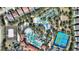 Aerial view of the community pool, lazy river, tennis court and surrounding community at 7012 Oakwood St, Davenport, FL 33837