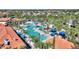 Aerial view of the community pool with plenty of lounge chairs, cabanas, and shade for fun and relaxation at 7012 Oakwood St, Davenport, FL 33837