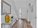 Bright entryway featuring wood flooring, console table with decor, and white walls at 7012 Oakwood St, Davenport, FL 33837