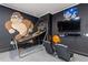 Fun game room features a basketball game, a TV and comfy seating for hours of entertainment at 7012 Oakwood St, Davenport, FL 33837