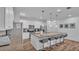 Modern kitchen features an island with bar seating, stainless steel appliances, and stylish pendant lighting at 7012 Oakwood St, Davenport, FL 33837