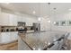 Well-equipped kitchen featuring granite countertops, stainless steel appliances and an eat-in island at 7012 Oakwood St, Davenport, FL 33837