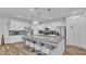 Bright kitchen with island with bar stool seating, granite countertops and stainless appliances at 7012 Oakwood St, Davenport, FL 33837