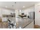 Spacious kitchen with granite countertops, stainless steel appliances, and a large island with seating at 7012 Oakwood St, Davenport, FL 33837
