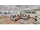 Spacious living room with a large sectional couch, hardwood floors, and neutral decor at 7012 Oakwood St, Davenport, FL 33837