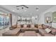 Open-concept living room with modern furnishings and seamless access to outdoor living spaces at 7012 Oakwood St, Davenport, FL 33837