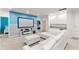 Bright living room featuring a large screen and comfortable white sectional sofa at 7012 Oakwood St, Davenport, FL 33837